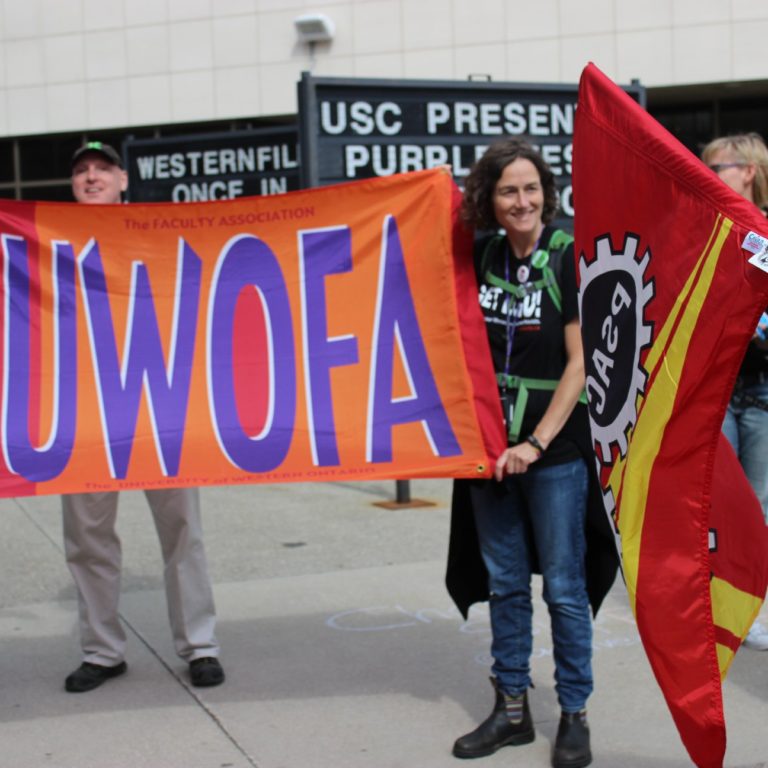people holding UWOFA flag