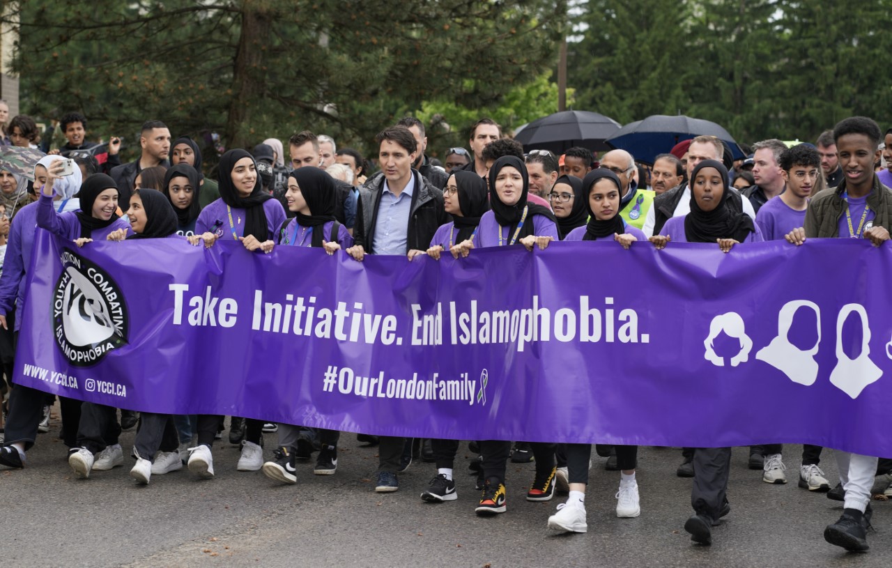 Western Students holding a banner saying "Take Initiative. End Islamophobia. #OurLondonFamily""